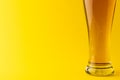 Horizontal image of pint glass of lager beer on yellow background, with copy space Royalty Free Stock Photo