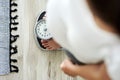 Horizontal image of woman standing on a bathroom scale