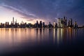 Horizontal image of the skyline of the westside of Manhattan at sunrise, with reflections seen in the Hudson