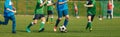 Horizontal Image of Soccer Competition. Junior Level Football Match. Players Running and Kicking Classic Soccer Ball Royalty Free Stock Photo