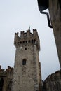 Horizontal image of the tower of Scaligero Castle in Sirmione on a cold and gray winter day. Royalty Free Stock Photo