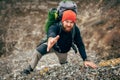 Horizontal image of traveler bearded man trekking and mountaineering during his journey. Royalty Free Stock Photo