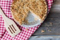 Whole apple crumble pie with a portion removed. Royalty Free Stock Photo