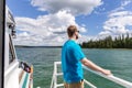 Young Attractive Man Standing On Deck Of Boat On Lake
