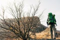 Horizontal landscape image of traveler bearded man trekking and mountaineering during his journey. Royalty Free Stock Photo