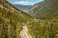 Winding Mountain Highway with Motorbike Rider in Distance Royalty Free Stock Photo