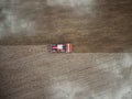 Red tractor plowing farm field aerial view looking down from above through clouds. Drone photo cultivation machine equipment work Royalty Free Stock Photo