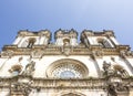 Low-angle shot of the facade of Alcobaca Monastery, or Mosteiro de Santa Maria de Alcobaca, in Portugal. No people.
