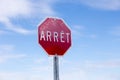 Horizontal low angle view of French stop sign encased in ice after ice storm Royalty Free Stock Photo