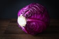 Low key image of a head of raw purple cabbage.