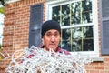 Horizontal of a man with tangled Christmas lights Royalty Free Stock Photo