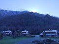 Horizontal mountain landscape with an apiary. Sunrise from behind the mountain