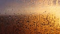 Horizontal natural background with water drops on the window with sunbeams, condensation on the glass with dripping drops Royalty Free Stock Photo