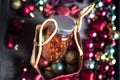Horizontal new year picture. Red present paper bag with bottle of fish fat pills inside and Christmas balls in