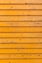 Horizontal old wood fence background. Old wooden planks with bright yellow paint Royalty Free Stock Photo