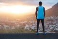 Horizontal panoramic view of thoughtful sportsman in sportclothes stands back to camera, admires majestic mountain