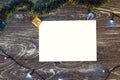 Horizontal paper blank with christmas lights frame. Flat lay. New year card gift. Gold presents, green tinsel. On grey wooden Royalty Free Stock Photo