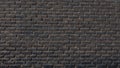 Horizontal part of dark brick wall background. Exterior wide old stone bricks Royalty Free Stock Photo