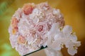 Classy floral arrangement in a pastel round bouquet featuring pink hydrangea roses and orchids