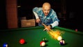 Horizontal photo angry man hits fireball at pool billiard