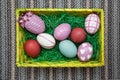 Horizontal photo of an Easter nest / Easter basket with colorful pastel eggs.
