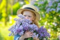 Horizontal photo of a girl smelling lilac flowers Royalty Free Stock Photo