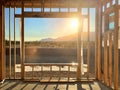 Window under construction frames a mountain view at sunrise