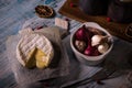 Hot camembert cheese on wooden board with garlic and onion Royalty Free Stock Photo