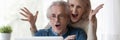 Horizontal photo mature couple looking at laptop screen feels excited Royalty Free Stock Photo