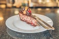 horizontal photo of a piece of chocolate cake with cherry on a plate on a table Royalty Free Stock Photo