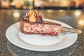 horizontal photo of a piece of chocolate cherry cake, the cake is on its side, on a plate on a table Royalty Free Stock Photo