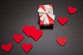 Present for Valentine`s day, Mother`s day or Wedding, wrapped in red paper, white bow and red hearts.