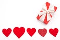 Present for Valentine`s day, Mother`s day or Wedding, wrapped in red paper, white bow and red hearts.