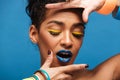 Horizontal photo of stylish mulatto woman with colorful makeup a Royalty Free Stock Photo