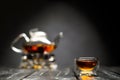 Horizontal photo of the tea set on a black background. Glass transparent teapot and cup. Black leaf tea. Royalty Free Stock Photo