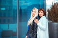 Horizontal photo of two adorable ladies blonde and brunette Royalty Free Stock Photo