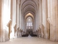 Alcobaca, Portugal - August 2018: Well-lit view of the Alcobaca Monastery`s nave towards the main chapel and ambulatory.