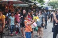 BANGKOK, THAILAND - October 2017: Thai boy shooting bubbles from bubble gun in Chatuchak Market. Mother taking pictures.