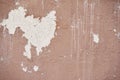 Horizontal photograph of the Abstract texture of terracotta painted stucco wall with peeling paint