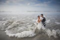 Bride and Groom Figurine in the Waves on the Beach