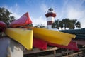 Colorful Kayaks In Front Of A Red And White Lighthouse