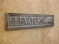 Vintage Elevator Sign on Marble Wall