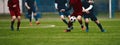 Horizontal picture of soccer match. Soccer football players competing for ball and kick ball during match in the stadium