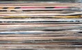 Horizontal pile of many close standing vinyl records covers as background front view closeup Royalty Free Stock Photo