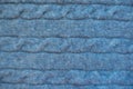 Horizontal plaits on blue knitted fabric