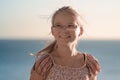 The horizontal portrait of cute teenager girl in glasses looking away and laughsing against the sea. Royalty Free Stock Photo