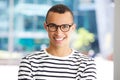 Horizontal portrait of handsome young man smiling with glasses