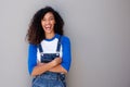 Portrait of happy young african american woman laughing against gray wall Royalty Free Stock Photo