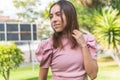 Horizontal portrait of a Latina teen girl with braces posing with her gaze to the side in a park Royalty Free Stock Photo