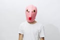 horizontal portrait of a man in a strange pink rubber mask